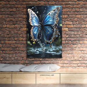 May include: A blue butterfly with gold accents is perched on a water droplet. The butterfly's wings are spread wide, and the water droplets are sparkling. The background is a dark blue, and the image is a close-up.