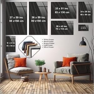 May include: A living room interior with two armchairs, a coffee table, and a floor lamp. The wall is decorated with framed artwork in various sizes. The artwork is black and white and features a geometric pattern. The text on the artwork includes measurements in inches and centimeters. The text below the artwork reads: "White Frame, Black Frame, Bronw Frame, Gold Frame, Silver Frame."