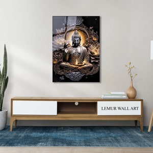 May include: A black and gold glass wall art print featuring a meditating Buddha figure surrounded by white flowers and a golden halo. The print is framed with a black border and has the text "LEMUR WALL ART" at the bottom.