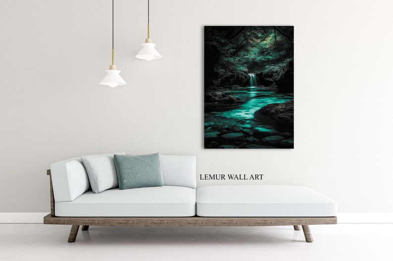 May include: A framed wall art print depicting a serene forest scene with a waterfall and a turquoise river. The artwork is displayed above a white sofa with a wooden frame. The text "LEMUR WALL ART" is visible.