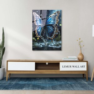 May include: A blue butterfly with gold accents is perched on a water droplet. The butterfly is surrounded by water droplets and a blurred background.