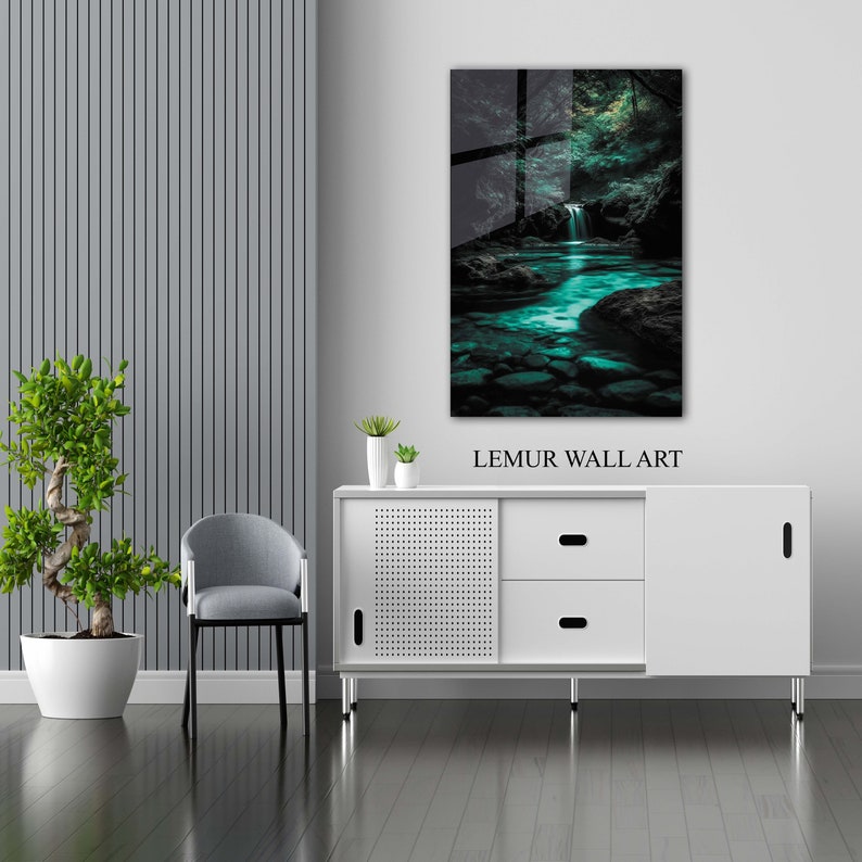 May include: A framed wall art print featuring a serene waterfall scene with turquoise water and lush green foliage. The artwork is displayed above a white cabinet. The text "LEMUR WALL ART" is visible.