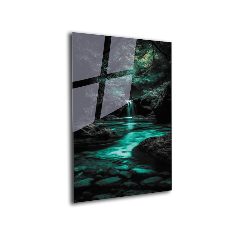 May include: A glass wall art piece featuring a serene waterfall scene. The artwork showcases a turquoise river flowing through a rocky landscape, surrounded by lush green foliage. The glass reflects the surrounding environment.