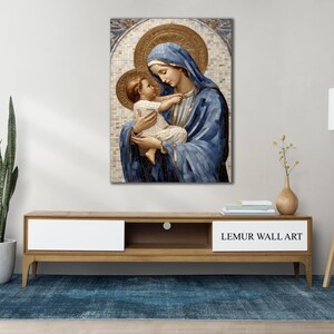 May include: A painting of the Virgin Mary holding a baby Jesus. The painting is done in a mosaic style with blue, gold, and white colors.