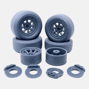 May include: A set of four gray plastic model car wheels with Goodyear tires, two gray plastic wheel hubs, and four gray plastic brake rotors.