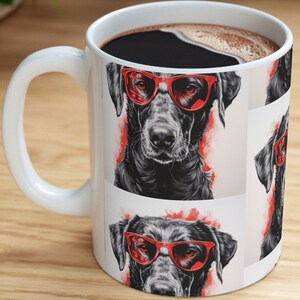 May include: White ceramic mug with a black dog wearing red sunglasses. The dog's image is repeated on the mug.
