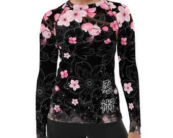 May include: Black long-sleeved shirt with a pink cherry blossom print and Japanese characters. The shirt has a crew neck and long sleeves.