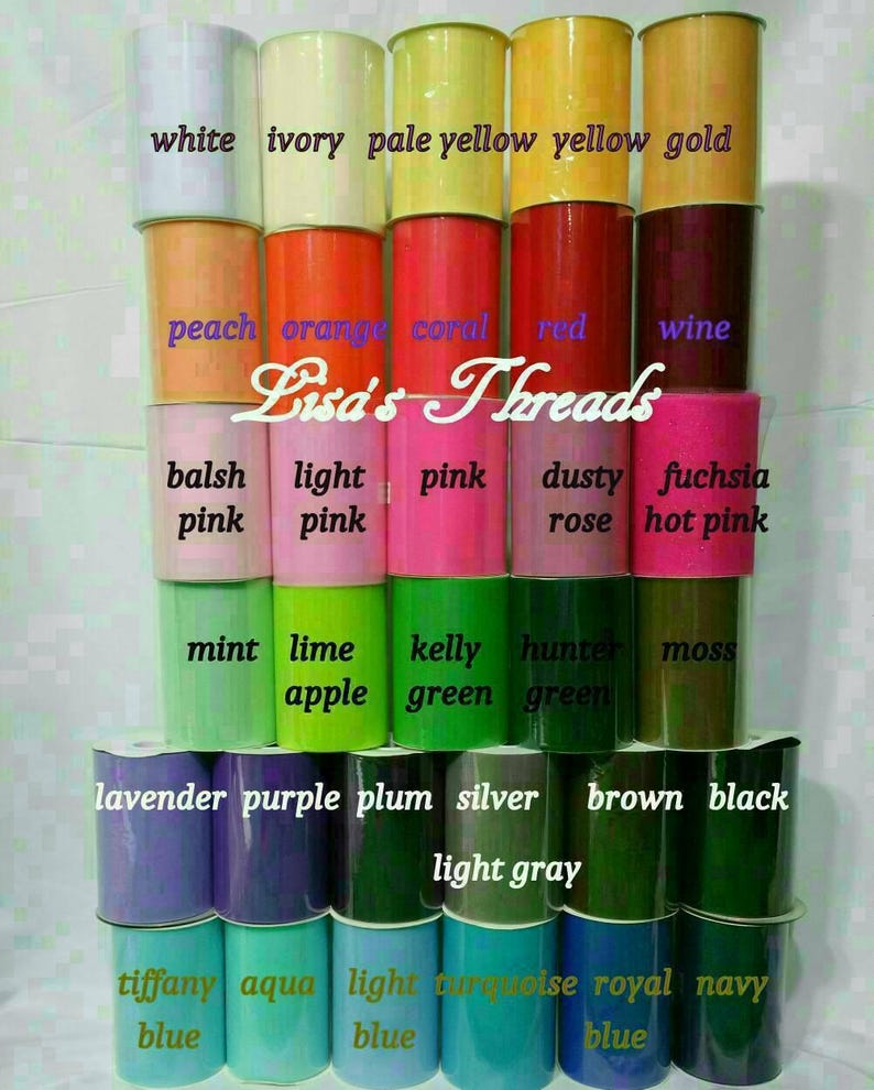 May include: A display of various colors of tulle fabric rolls, including white, pink, green, and blue. Each roll is labeled with its color name. The text "Lisa's Threads" is also visible.