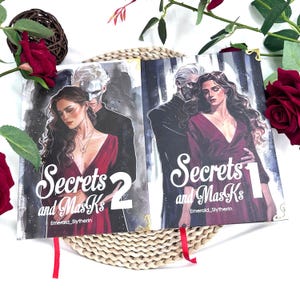 Secrets and Masks book. Hardcover. Complete set. 2-volume hardcover collection with 2 bonus posters
