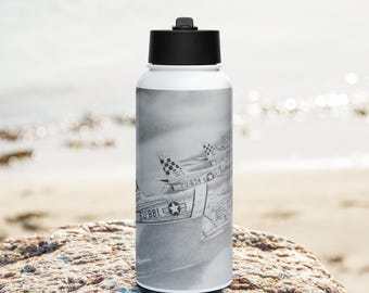 May include: A white water bottle with a black lid and a black and white image of four fighter jets flying in formation. The jets are labeled with the text "FU-874" and "FU-881".