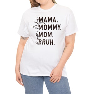 May include: White t-shirt with black text that reads "Little Mama. Mommy. Mom.  Bruh."
