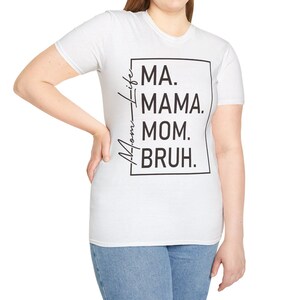 May include: White t-shirt with black text that reads "Mom-Life MA. MAMA. MOM. BRUH."