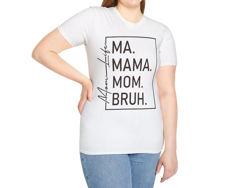 May include: White t-shirt with black text that reads "Mom-Life MA. MAMA. MOM. BRUH."