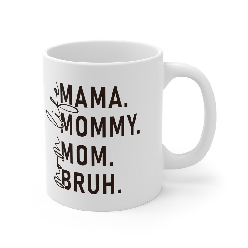 May include: White ceramic coffee mug with black text that reads "Mama. Mommy. Mom.  Bruh."