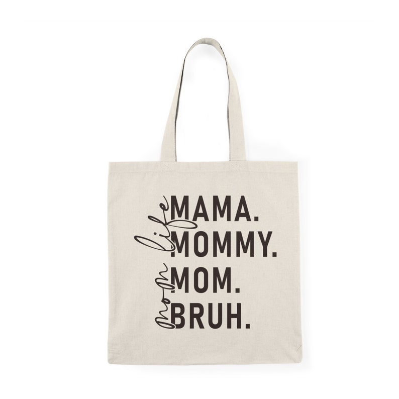 May include: A beige tote bag with black text that reads "Mama. Mommy. Mom.  Bruh."