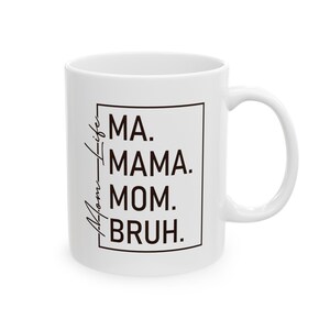 May include: White ceramic mug with a black square design that says "Ma. Mama. Mom.  Bruh." in a handwritten font. The text is centered in the square.