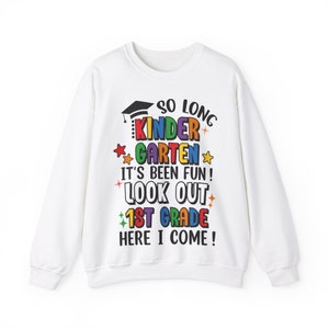 May include: White sweatshirt with a colorful graphic that says "So Long Kindergarten It's Been Fun! Look Out 1st Grade Here I Come!"