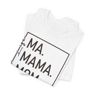 May include: White t-shirt with black text that reads "Ma. Mama. Mom" inside a black square.