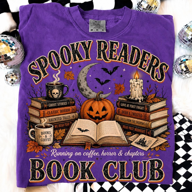 May include: A purple t-shirt featuring a graphic of a jack-o'-lantern, an open book, stacks of books, a candle, and mugs. The text reads SPOOKY READERS, BOOK CLUB, and Running on coffee, horror & chapters. The design includes bats, leaves, and a crescent moon.