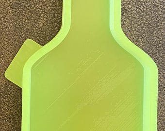 May include: A bright green plastic mould shaped like a cowboy hat. The mould has a smooth, slightly textured surface.