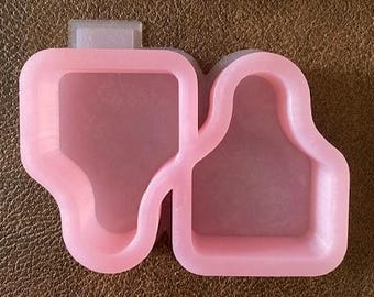 May include: Pink silicone mould with two separate cavities shaped like thumbs up. The mould is designed for making resin crafts.