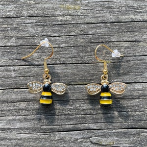 Handmade cute honey bee earrings made from metal earrings and bee charms.