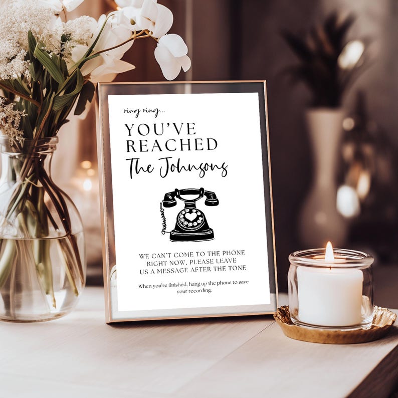 a vase with flowers and a sign on a table