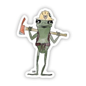 May include: A green frog wearing a yellow hard hat with the letters "OAH" on it, holding a red-handled axe over its shoulder. The frog is wearing a brown backpack and a brown belt. The frog is standing on a white background.