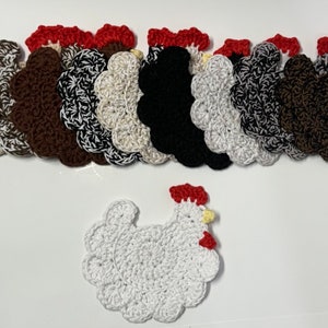 May include: A set of ten crocheted chicken coasters in various colors, including brown, black, white, and cream. The coasters are arranged in a semi-circle with a single white crocheted chicken in the center.