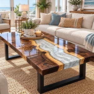 May include: A rectangular coffee table featuring a live edge dark wood slab with a central, flowing river-like inlay of pearlescent white epoxy resin. The table is supported by two black metal U-shaped legs and has a polished, high-gloss finish.