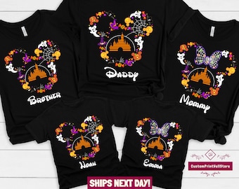 May include: Black t-shirts with a Halloween Mickey Mouse design featuring a Mickey Mouse head silhouette with a  castle, ghosts, bats, candy, and a spider web. The shirts have the words "Brother", "Daddy", "Mommy", "Noah", and "Emma" printed on them.