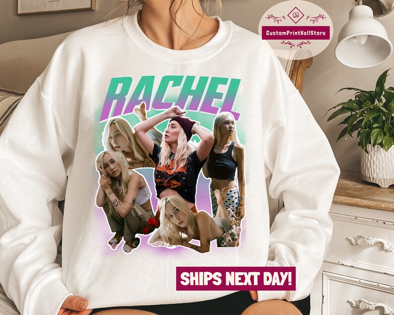 May include: White sweatshirt with a green and purple gradient background. The text "RACHEL" is printed in large, bold letters. The sweatshirt features a collage of four women with different hairstyles and clothing.