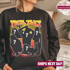 May include: Black sweatshirt with a graphic print of five silhouettes of people with question marks over their heads. The text "YOUR TEXT" is printed in yellow and orange letters above the silhouettes.