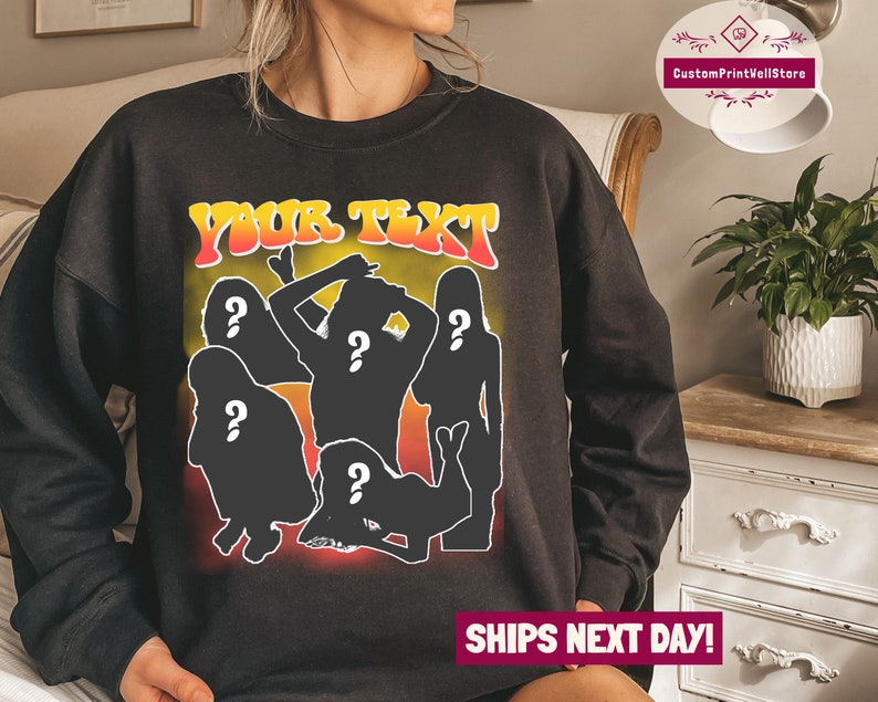 May include: Black sweatshirt with a graphic print of five silhouettes of people with question marks over their heads. The text "YOUR TEXT" is printed in yellow and orange letters above the silhouettes.