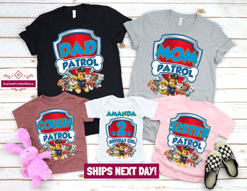 May include: Five t-shirts featuring the Paw Patrol characters. The shirts say "Dad Patrol", "Mom Patrol", "Cousin Patrol", "Sister Patrol", and "Amanda 2nd Birthday Girl".