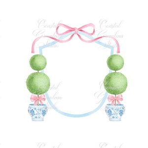 May include: A blue and white ceramic planter with a pink bow sits on a blue and white pedestal. The planter holds a topiary tree with three green spheres. The planter is framed by a blue and white oval with a pink bow at the top.