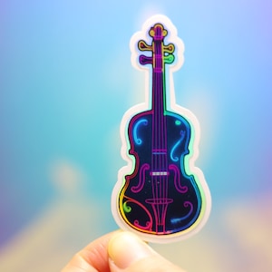 May include: A holographic sticker of a violin with a black body and neon rainbow trim. The violin's outline and strings are highlighted with vibrant colors, creating a glowing effect against a gradient blue background.