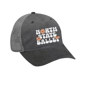 May include: A black and gray trucker hat with a white retro font design that says "North State Ballet" with three orange flowers.