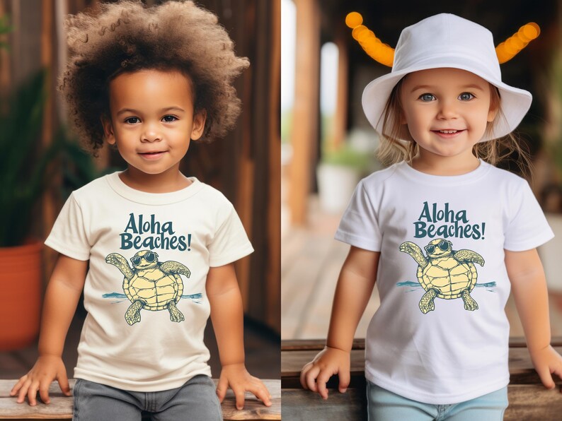 Pu&ograve; includere: Due bambini con magliette bianche e color crema. Le magliette presentano una tartaruga dei cartoni animati con occhiali da sole con la scritta "Aloha Beaches!" in blu. I bambini sorridono e guardano la fotocamera.