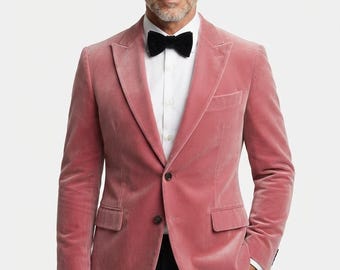 May include: A pink velvet blazer with a notched lapel, two front buttons, and two flap pockets. The blazer is worn over a crisp white button-down shirt and a solid black bow tie, paired with black trousers to complete the formal ensemble.