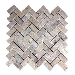 May include: A rectangular mosaic tile sheet featuring small, rectangular stone pieces arranged in a herringbone pattern. The tiles exhibit a natural, porous texture with varied shades of beige, tan, and light gray throughout the surface.