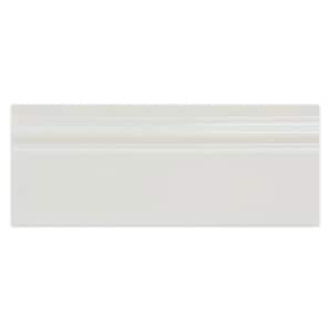 May include: A rectangular white baseboard molding piece with a smooth, flat surface and a decorative, rounded profile along the top edge. The molding features a clean, uniform finish and a consistent off-white color throughout its entire length.