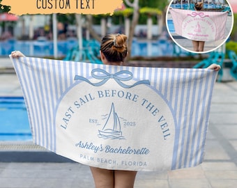 May include: A beach towel with blue and white vertical stripes and the text "LAST SAIL BEFORE THE VEIL" in a circular design. The design includes a sailboat illustration and the text "Ashley's Bachelorette, Palm Beach, Florida".