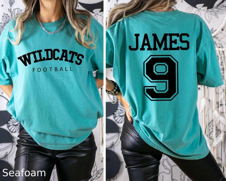 May include: A turquoise blue t-shirt with the text "Wildcats Football" on the front and the text "JAMES 9" on the back.