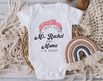 May include: White baby onesie with a pink bandana design and the text "I only love Ms. Rachel & my Mama I'm sorry".