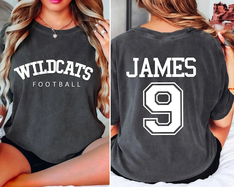 May include: Two gray t-shirts with white text. The first shirt says "Wildcats Football" and the second shirt says "James 9".