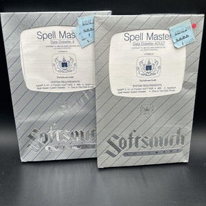 May include: Two vintage software boxes for "Spell Master" data diskettes. The boxes are silver with diagonal stripes and feature the "Softsmith Software" logo. One box is labeled "Data Diskette-4" and the other "Data Diskette-ADULT".