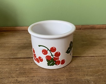 May include: White ceramic jar with a red and green design of red currants on a vine.