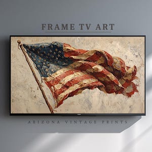 May include: A framed digital artwork of the American flag, rendered in a textured, painterly style. The flag's red and white stripes and blue field of stars are prominently displayed, with the text "FRAME TV ART" and "ARIZONA VINTAGE PRINTS" above and below the image.