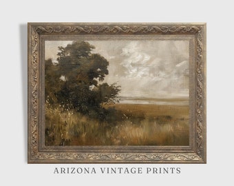 May include: A vintage landscape painting in a gold frame. The painting depicts a field with a large tree in the foreground and a body of water in the background. The sky is cloudy and the colors are muted.